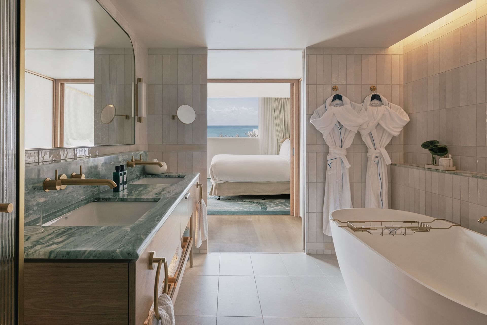 Elysium Hotels bathroom with robes by a soaking tub overlooking the bedroom, best 5-star hotels in New South Wales