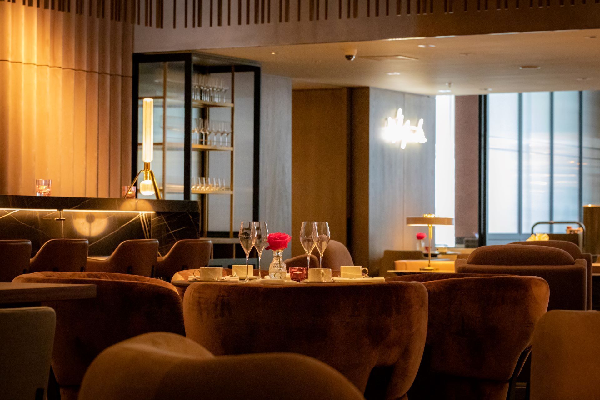 An inviting and sophisticated lounge area with comfortable seating and soft lighting for relaxation at The Londoner Hotel