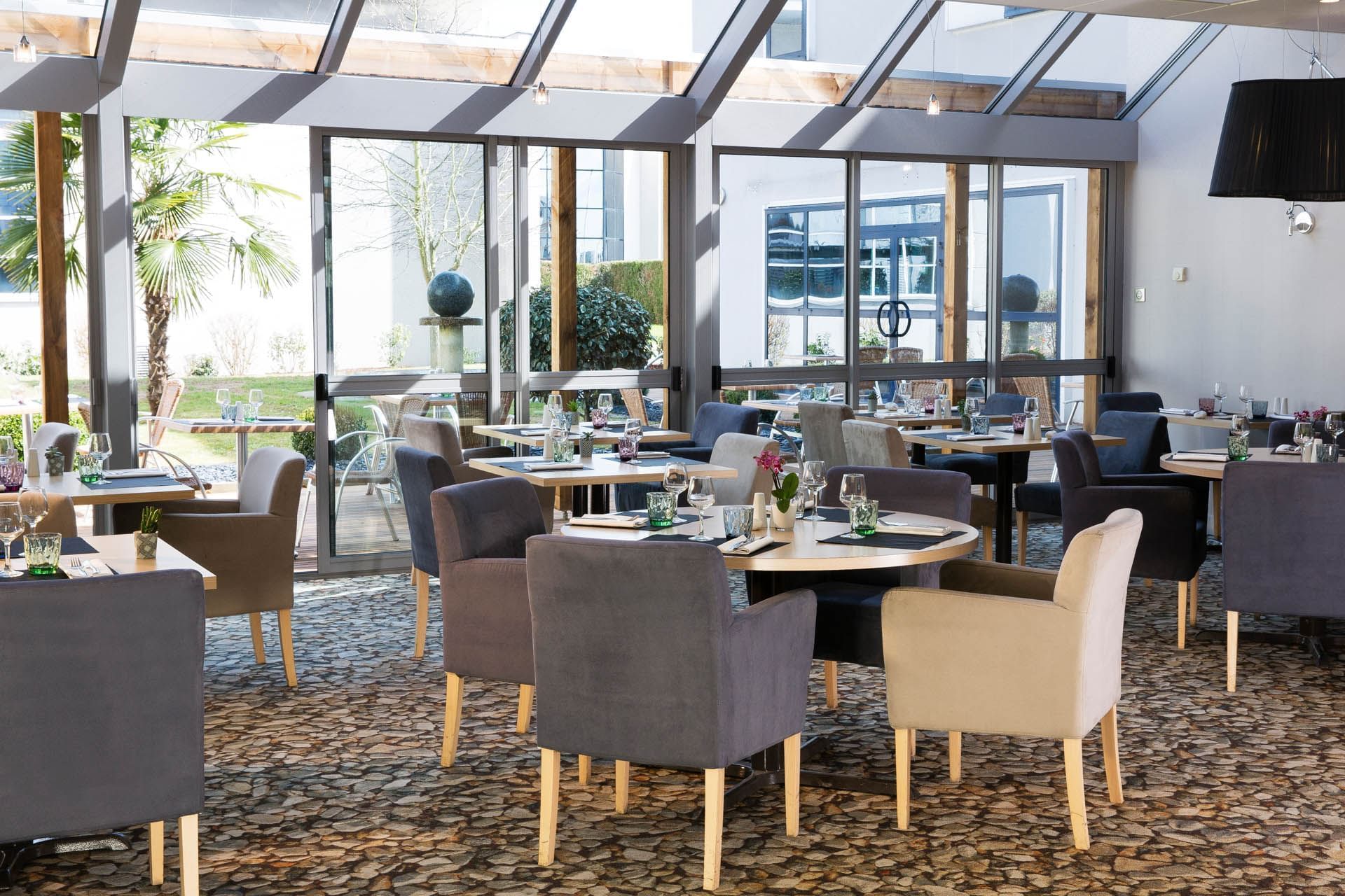 Dining tables arranged in the Restaurant at Oceania Rennes