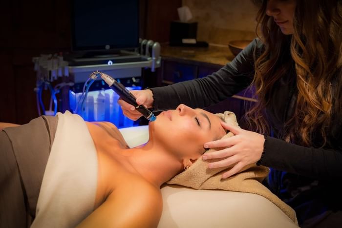 A woman getting a facial at The Spa at Stein Eriksen Lodge