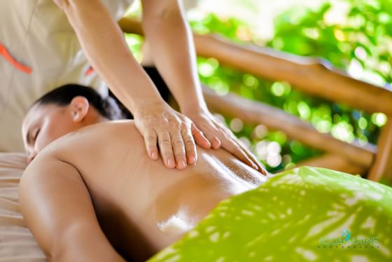 A girl having a back massage in Heliconia Spa at Fiesta Resort