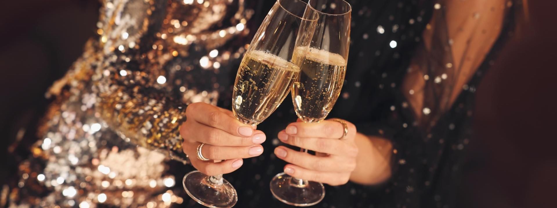 Two hands toasting with champagne glasses, celebrating at Novotel Sydney on Darling Harbour
