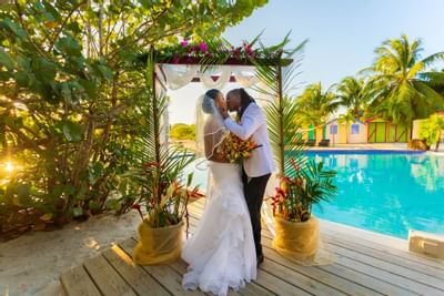 Bride & groom kissing in the ceremony at True Blue Bay Hotel