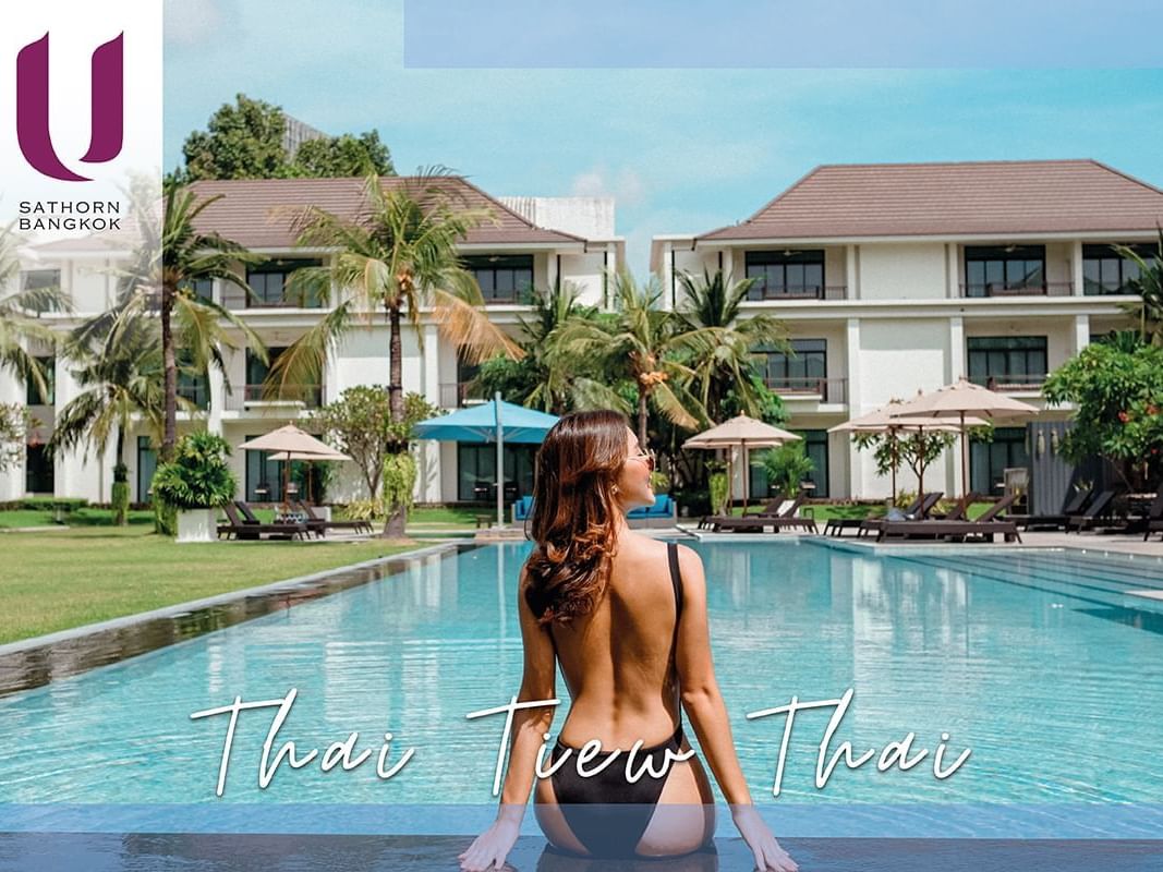 Lady sitting on the swimming pool at U Hotels and Resorts