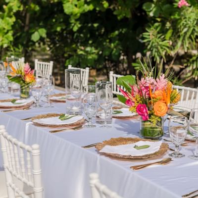 Long banquet table with floral centerpieces and decor at Barefoot Cay Resort & Marina