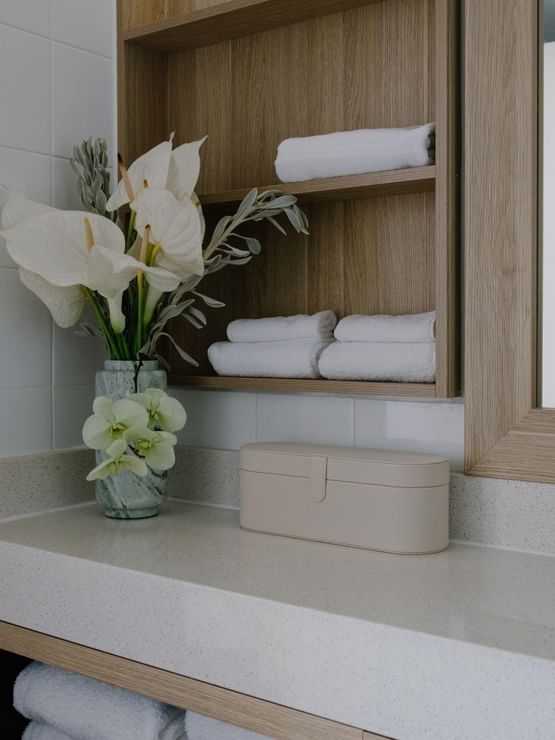 Sunset Junior Suite at Elysium Manly, featuring white floral arrangements & neatly folded towels, an apartment hotel in Manly