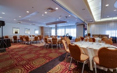 Event space set with banquet rounds.