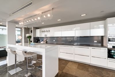 kitchen with white cabinets and white island with seating