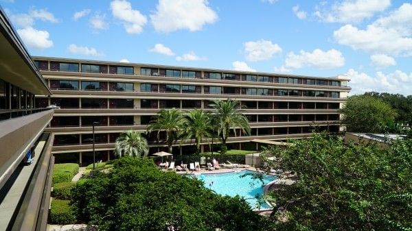 Blue skies reflecting on a sparkling swimming pool at Rosen Inn at Pointe Orlando, a family-friendly hotel near Walt Disney World in Orlando.