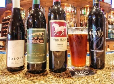 Wine bottles and a draft beer