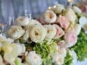 Elegant wedding centerpiece featuring a lush arrangement of white and pale pink roses in a bouquet at The Sebel Brisbane