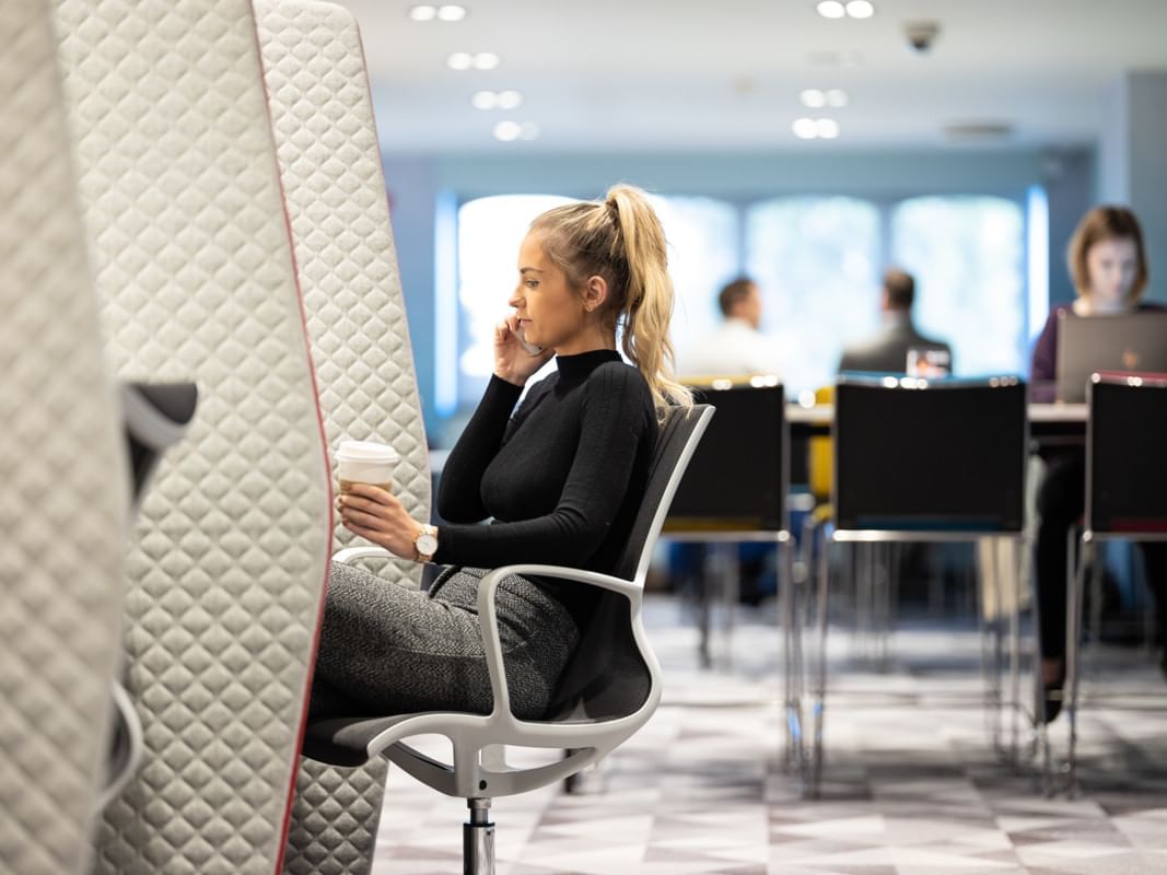 Girl in a phone call while working at Village Hotels