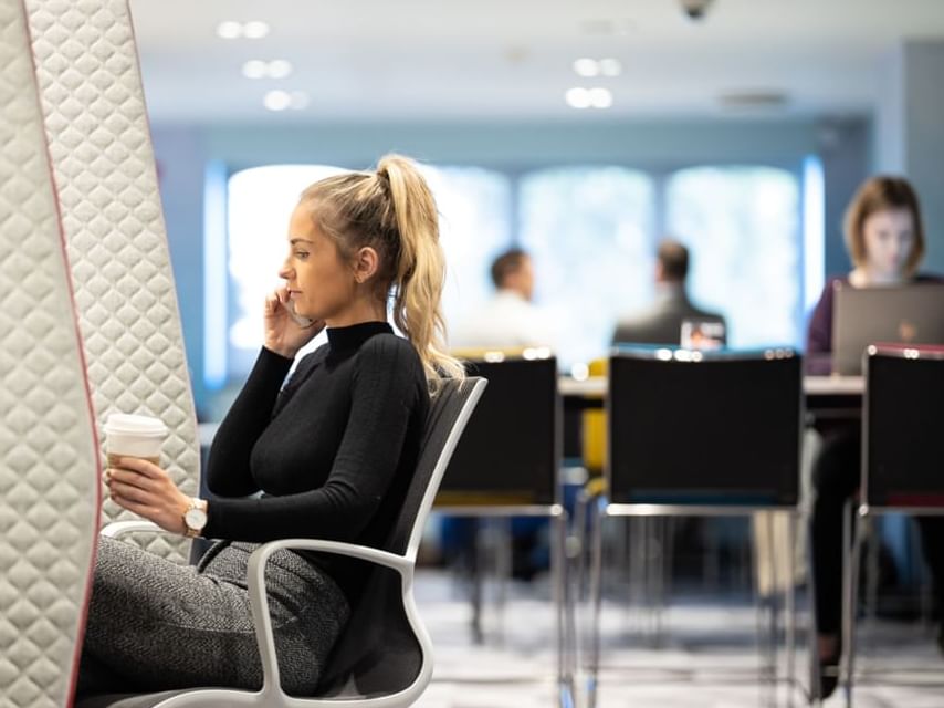 A lady on a call in a Meeting Space at Village Hotel Birmingham