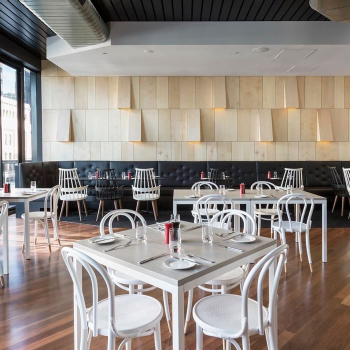 Ibis Kitchen Restaurant dining area featuring modern white and black seating at Ibis Adelaide