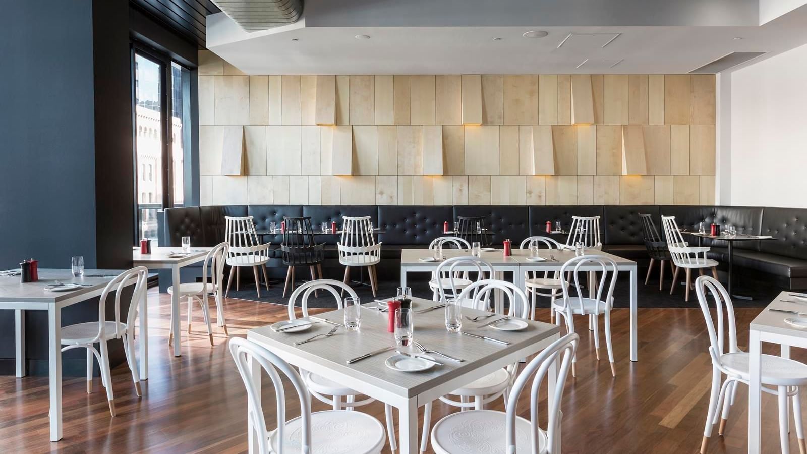 Ibis Kitchen Restaurant dining area featuring modern white and black seating at Ibis Adelaide