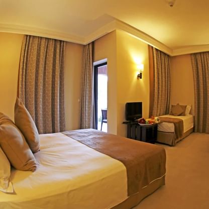 Bed & furniture in the Family room at Labranda Targa Aqua Parc