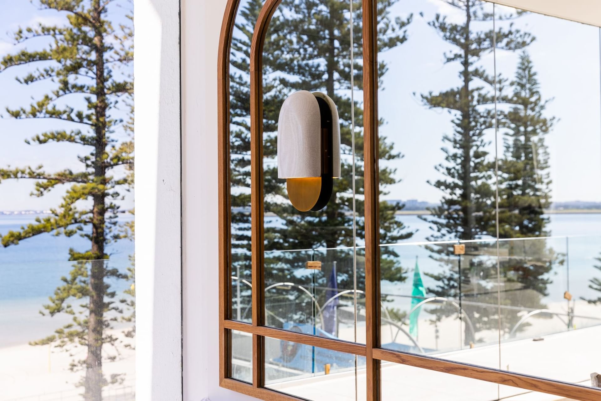 View of the Beach with Pine Trees | Novotel Sydney Brighton Beach