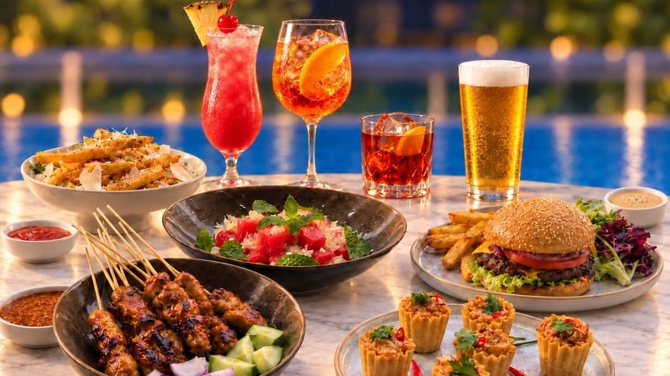 Colorful cocktails and beer alongside appetizers and a burger by a poolside setting for Sip & Chill