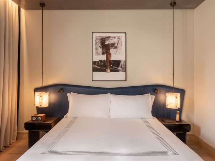 Plush bed beside cube lamps and nightstands in 1 King Bed at Thompson Rome, highlighting luxury rooms in Rome