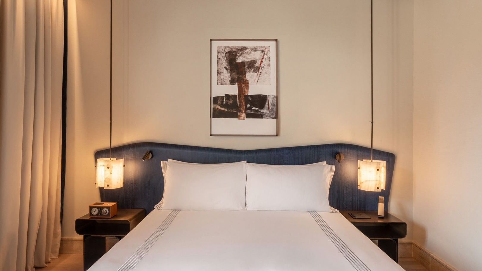 Plush bed beside cube lamps and nightstands in 1 King Bed at Thompson Rome, highlighting luxury rooms in Rome