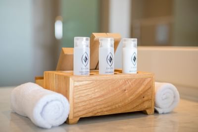 Mini shampoo bottles with towels in Two Bedroom Suite at Eastin Ashta Resort Canggu