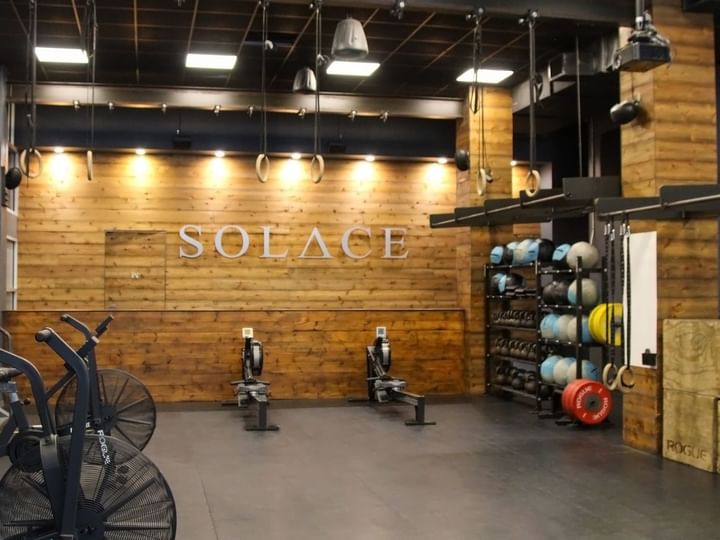 a gym with wooden walls and exercise equipment