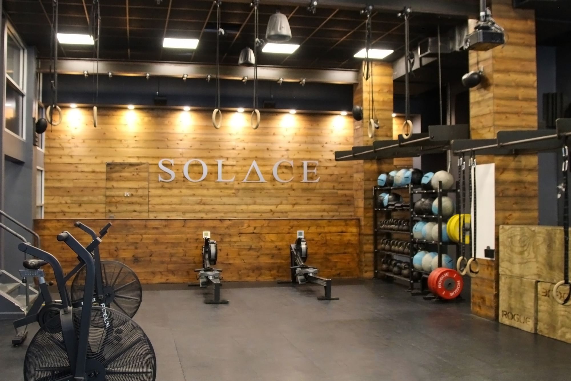 a gym with wooden walls and exercise equipment