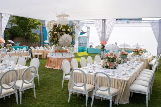 Dining tables arranged for an event in Garden, Araiza Mexicali