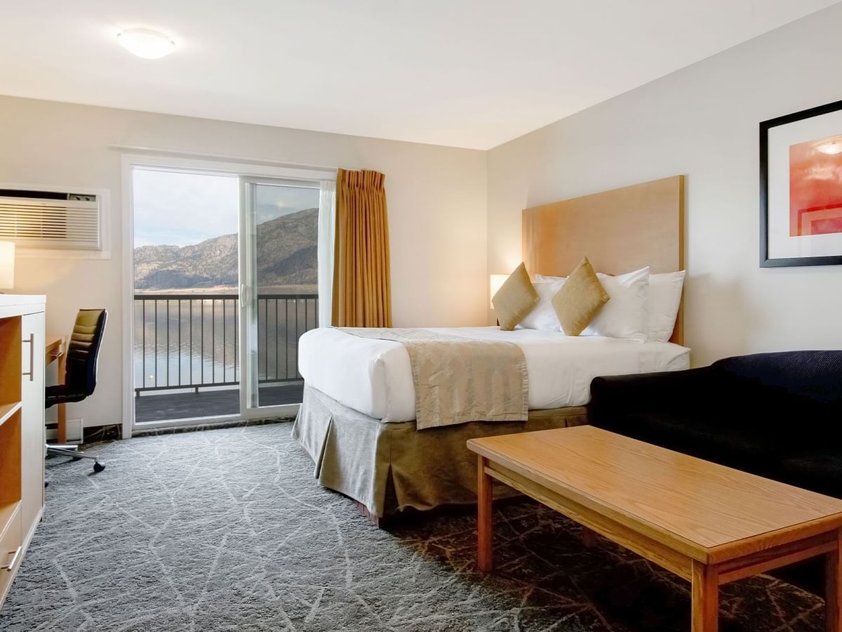 Modern hotel room with two queen beds, balcony access and stunning lake views.