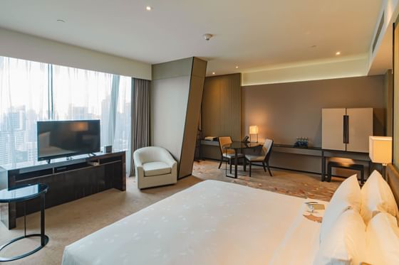 King bed with a TV in Premier Club at Okura Prestige Bangkok