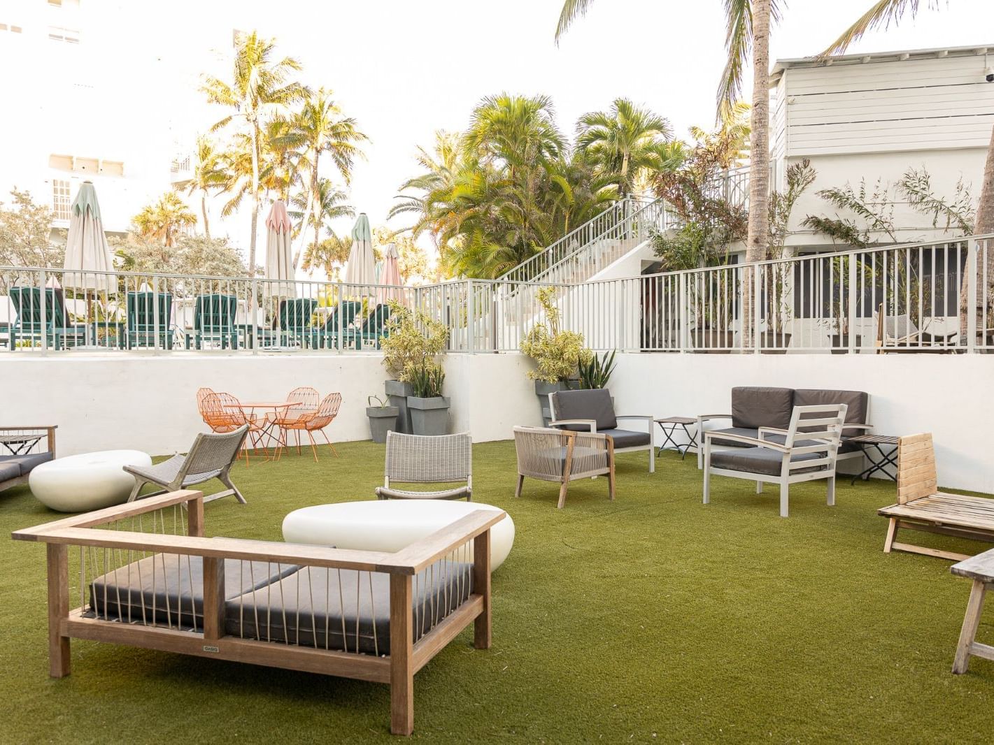 Outdoor seating area with lounge chairs in Turf Courtyard at The Savoy On South Beach