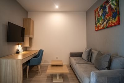 Sofa facing TV and workspace in Interconnected Suites at The Hub Acunmeyda