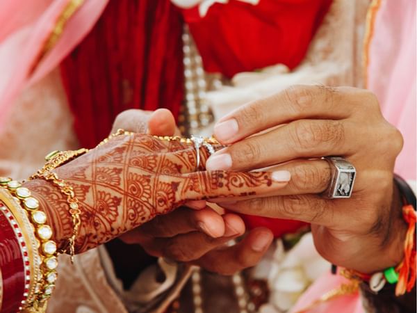 Close-up of the groom placing a ring on the bride's hand at Hotel Maya Kuala Lumpur City Centre