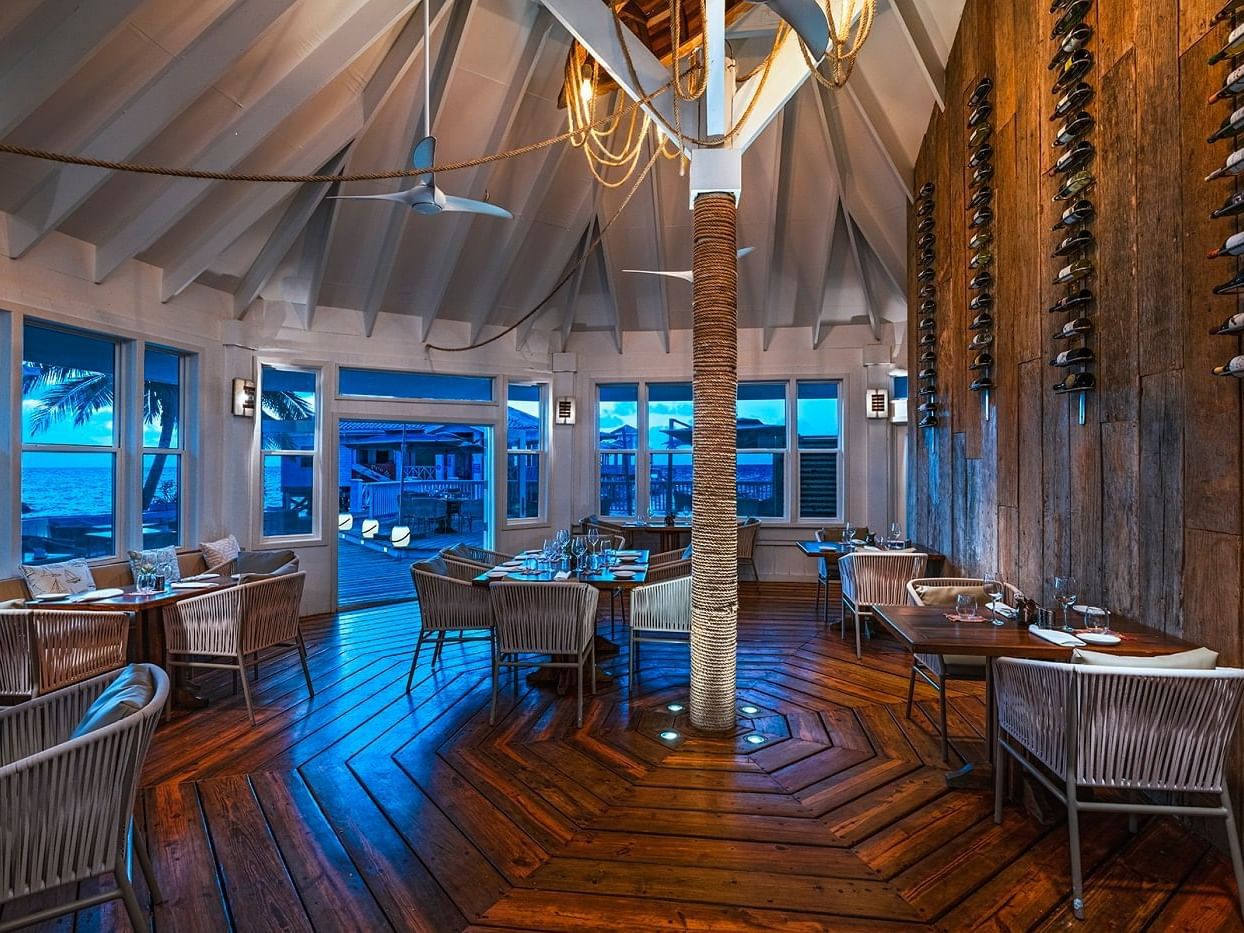 The Deck interior with arranged dining tables at Alaia Belize Autograph Collection