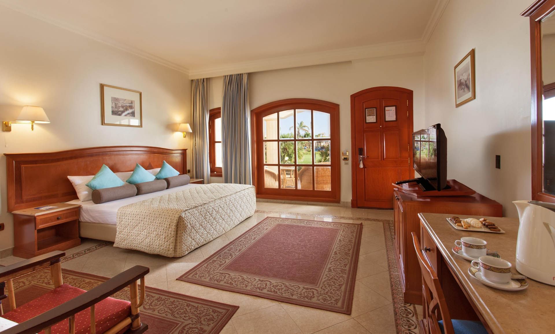 Modern room at Pickalbatros Golf Beach Resort with a cozy bed, TV, and a garden view, All-inclusive Resort Sharm El Sheikh
