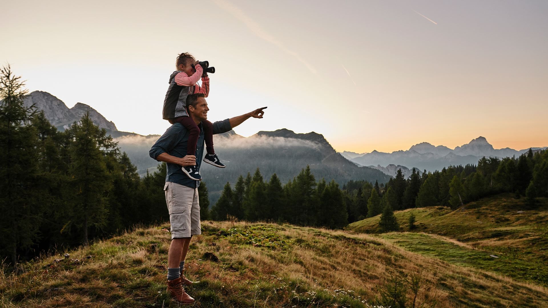 A kid on dad's shoulders exploring near Falkensteiner Hotels