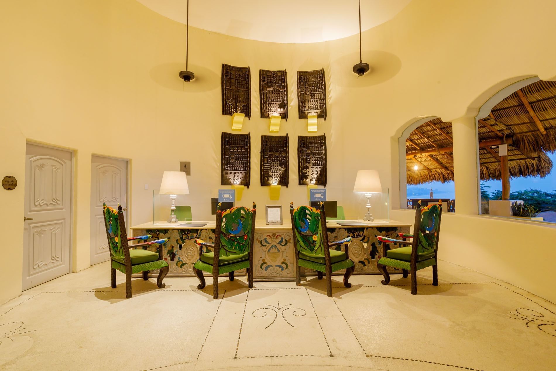 Beautifully detailed reception with ornate green chairs and traditional Mexican decor at Quinta Real Acapulco