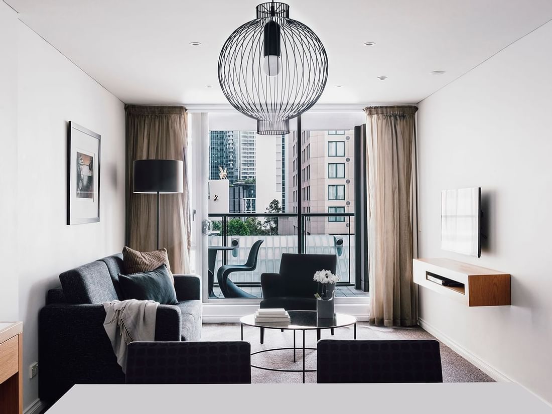 Interior of 2 Bedroom 2 Bathroom Superior Suite living room with a balcony at Quay West Suites Melbourne