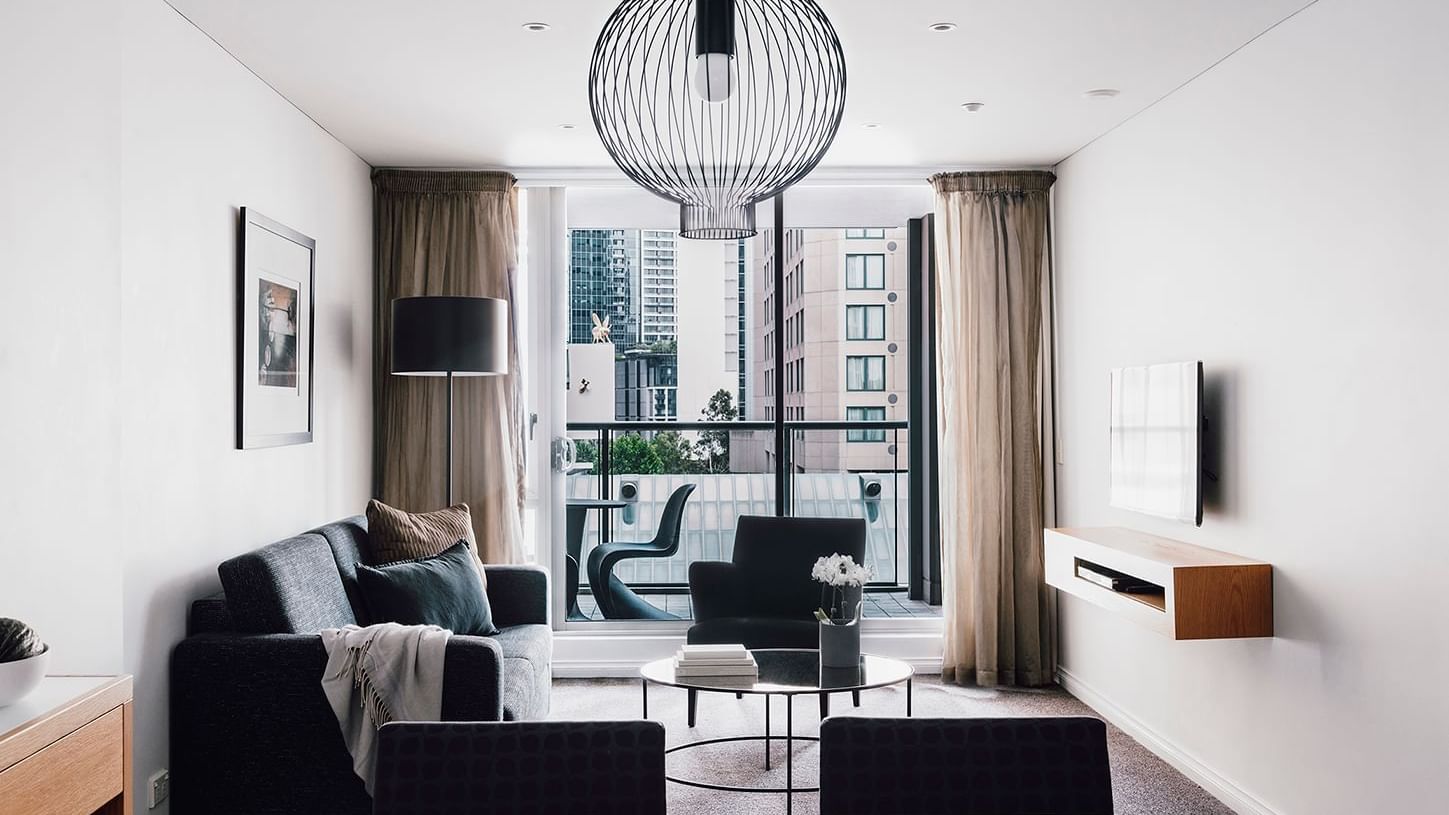 Interior of 2 Bedroom 2 Bathroom Superior Suite living room with a balcony at Quay West Suites Melbourne