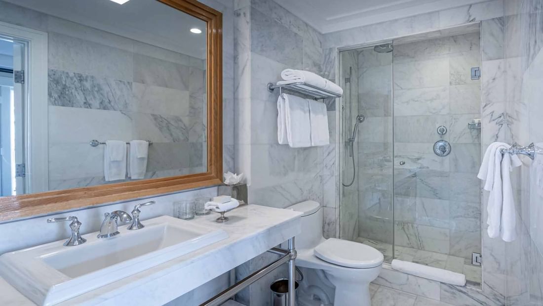 Bathroom interior with vanity and shower area in Deluxe Junior King Suite at El Prado Hotel