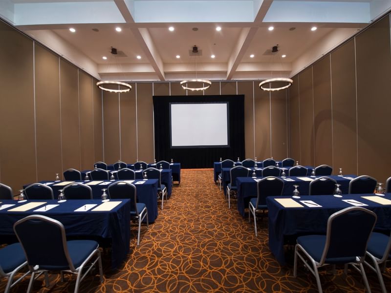 Classroom set-up with projector screen in a meeting room at Grand Fiesta Americana