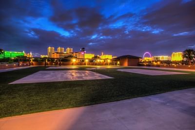 Outdoor lawn by a pathway at Alexis Park Resort