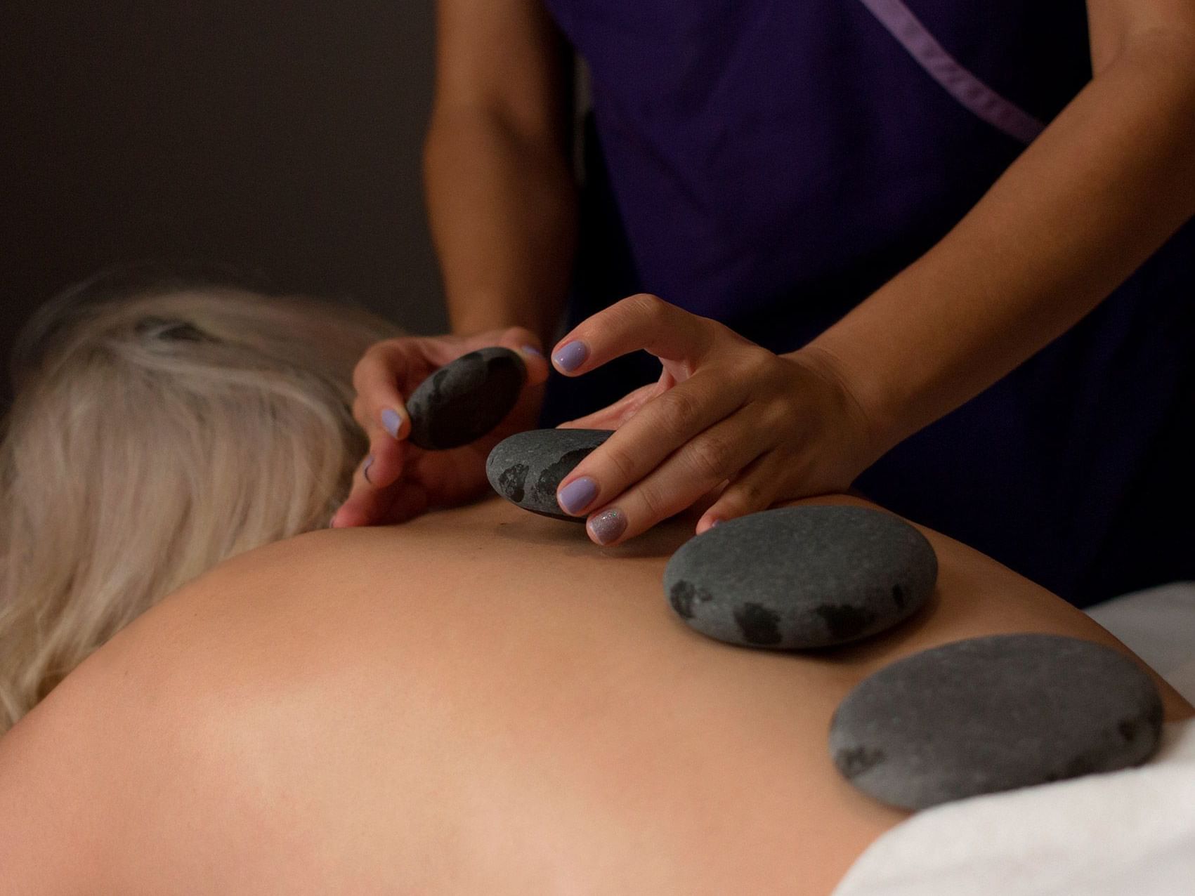 A Lady getting a Hot stone massage at Central Hotel Panama Spa