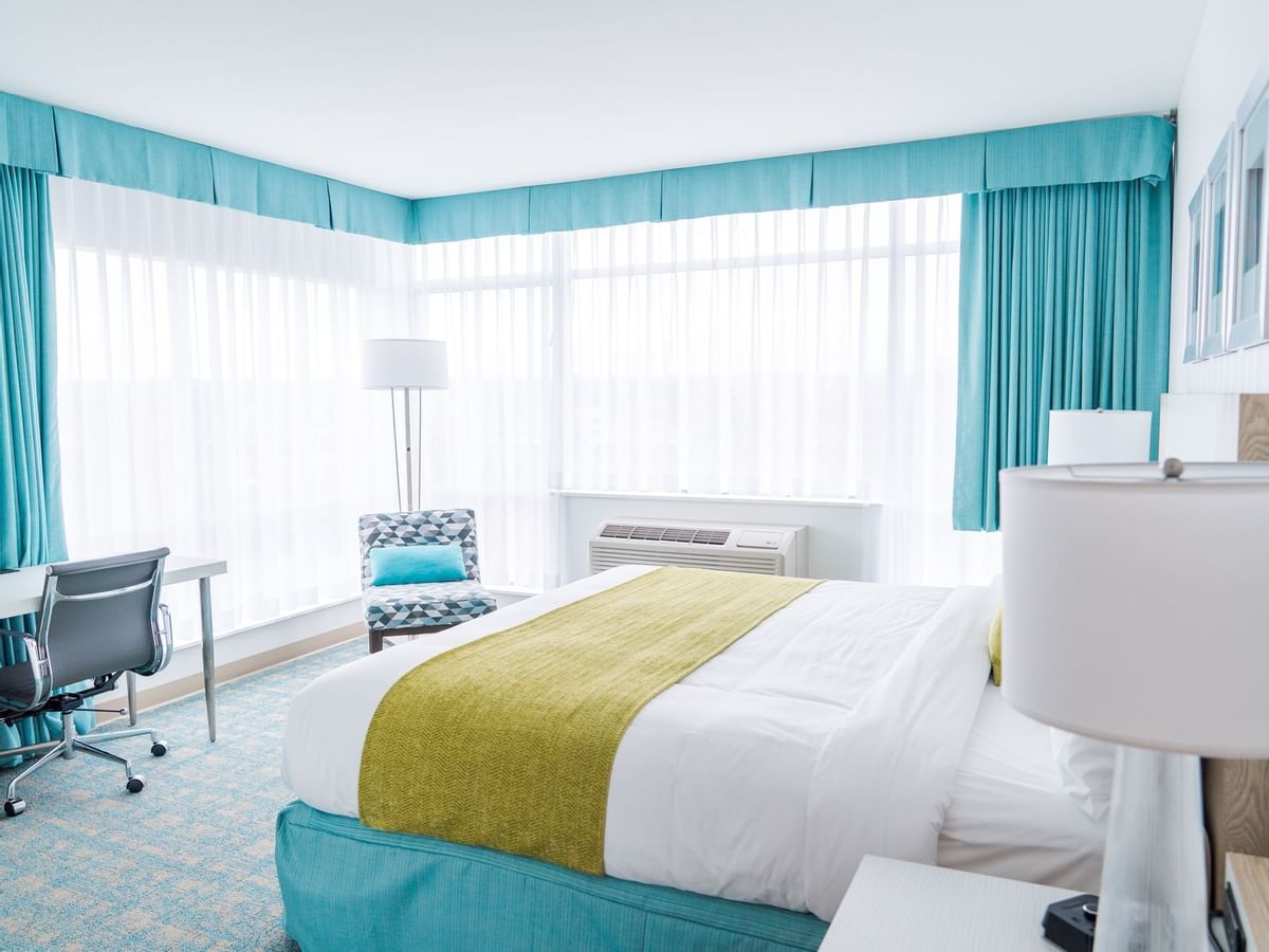 Bed in hotel room with green and blue colors