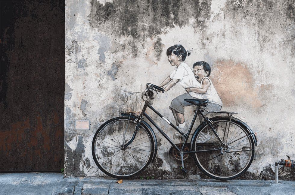 Street mural art of two kids riding a bicycle near Sunway Hotel Georgetown