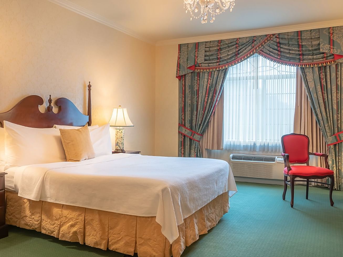 Bristol Boutique Hotel Campbell San Jose - Executive Suite King Bed Cherrywood furniture and curtains flanking window 