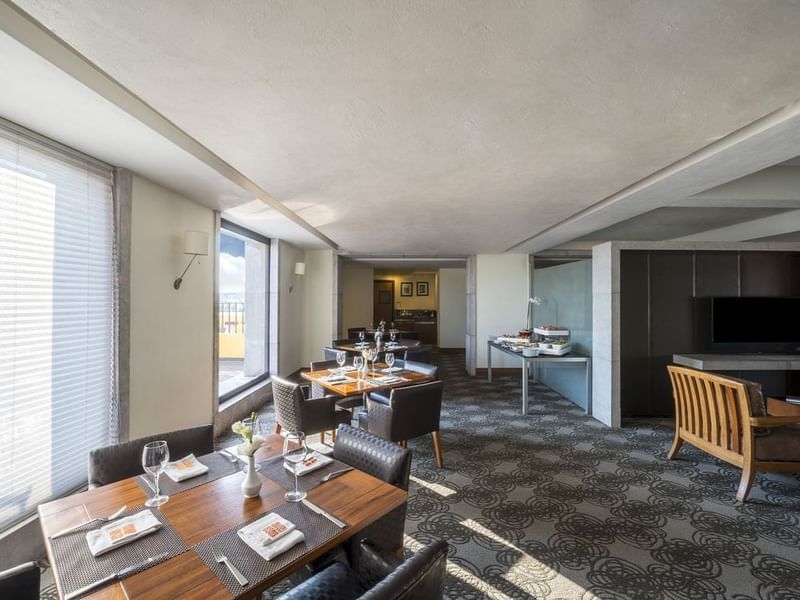 Master Suite, 1 King with set tables, windows with blinds, a patterned carpet, and a buffet station at Grand Fiesta Americana