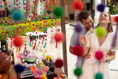 Couple embracing near a market stall with crafts and flowers at Villa Premiere Boutique Hotel & Romantic Getaway