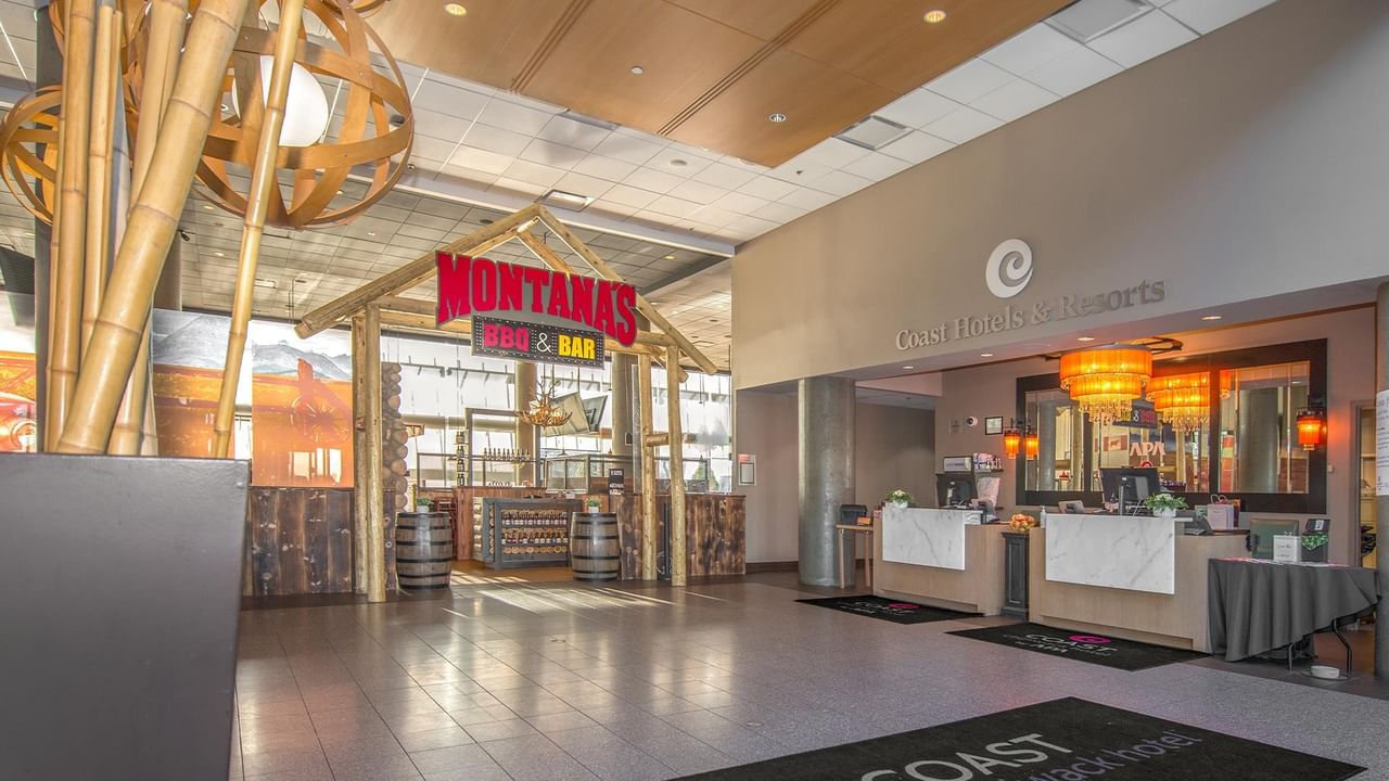 Lobby entrance with reception desk and signage for Montana's BBQ & Bar.