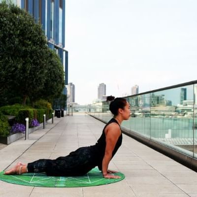 A lady doing yoga outdoor at Hotel Mont Gabriel Resort & Spa